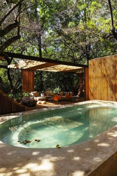 an outdoor swimming pool surrounded by trees