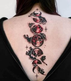 the back of a woman's neck with tattoos on it and phases in different colors