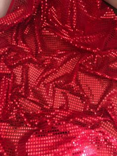 red sequin dress laying on the floor