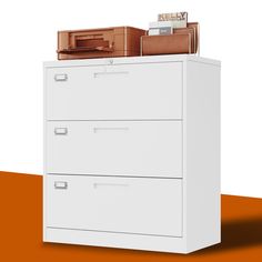 a white filing cabinet with two file cabinets on top and an orange floor next to it