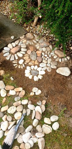 there is a circle made out of rocks with a shovel on the ground next to it