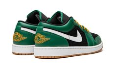 The Air Jordan 1 Low SE “Holiday Special” is a colorway of the lifestyle shoe inspired by the holiday season, specifically Christmas.  The shoe features a black leather base with a subtle geometric pattern.  Contrasting green leather overlays and a white leather Swoosh add to the look.  A yellow “Wings” logo is embroidered on the heel and a red Jumpman is paired with green “Air” branding on the black nylon tongue.  The shoe’s yellow laces add a pop of color to the design.  Underfoot, a white mid Jordan Lows, Sneaker Displays, Sneakers Box, Kobe Shoes, Malachite Green, Nike Air Jordan 1 Low, Christmas Shoes, Wings Logo, Sneaker Release