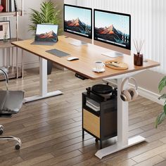 a computer desk with two computers on top of it and a plant in the corner