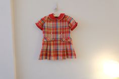 "1960's Vintage Girls Cotton/Poly Red Green Blue Plaid Mod Aline Shift Dress Dropped Waist Pleated Full Skirt Short Sleeve Flat Collar-size S label--JCPenney red flat rounded collar with white piping  *  zipper closure back of bodice metal hook and eye top of zipper  *  short sleeves with folded cuffs  *  dropped waist   *  full pleated skirt no belt  *  no lining  *no pockets modern size S Soft, mediumweight cotton/poly fabric--woven, no stretch!! Measurements Flat: Dress 12.5\" back shoulder 14.5\" across chest at bottom of armhole 15\" waist flat 15\" hip 3.25\" hem 23.75\" total length top shoulder front to hem Hand washed and hung dry and ready to wear! Excellent condition! Spots front skirt, right side seam coming undone,  Please check out all of my fabulous ETSY items on Lulavintage Retro Short Sleeve School Dresses, Retro Fitted School Dress, Retro Fitted Dress For School, Red Short Sleeve School Dress, Retro Cotton School Dress, Preppy Red Cotton Dress, Red Preppy Cotton Dress, Pleated Shift Dress, Red Flats