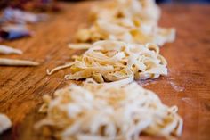 some kind of food that is on a wooden table and ready to be cut up