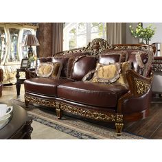 a brown leather couch sitting on top of a wooden floor