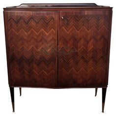 an art deco style cabinet with chevroned wood