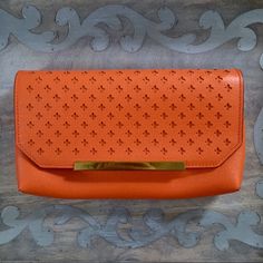 New With Tags! Gorgeous Orange Clutch With A Beautiful Soft Suede Lining. Small Pin Hole Shown In Picture, Not Noticeable. Back Pocket With Magnetic Closure, Suede Lines 2 Pockets Inside With A Zip Compartment 10”X5.5” Chic Orange Clutch, Off Shoulder Bathing Suit, Orange Clutch, Cork Clutch, Leopard Clutch, Silk Clutch, Green Clutches, Glitter Clutch, Leather Waist Bag