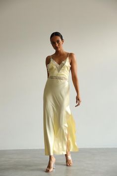 This long white Slip Dress made of soft pure mulberry silk. A V-neckline with lace, open back with adjustable spaghetti straps, meet a bias cut to fall beautifully against the body, inspiring a feminine silhouette. Effortless for both day and night, for romantic evening or as a bridal getting ready dress.   Model is 168 cm, 84/64/89 wears size XS Total length 135 cm from the shoulder  Off white color Evening Slip Dress With Lace Trim And Spaghetti Straps, V-neck Slip Dress With Delicate Straps For Wedding, Silk Slip Dress With Lace Bodice For Evening, Fitted Satin Slip Dress With Lace Back, Lace Slip Dress With Delicate Straps For Evening, Evening Lace Slip Dress With Delicate Straps, Silk Night Dress With Delicate Lace, Night Silk Dress With Delicate Lace, Elegant V-neck Slip Dress With Lace Back