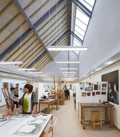 an artist's studio with people working on their paintings