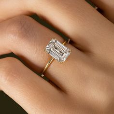 a woman's hand with a diamond ring on it