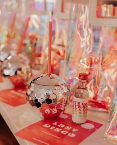 there are many items on the table for sale at this store, including bottles and candles