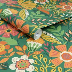 a green floral wallpaper with orange, yellow and pink flowers on the outside of it