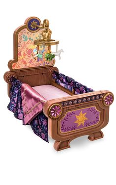 a wooden toy bed with princess decorations on the headboard and foot board, sitting in front of a white background