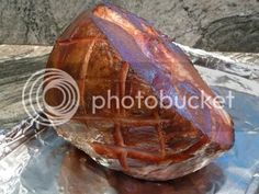 a large piece of meat sitting on top of aluminum foil