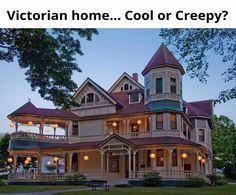 an old victorian style house lit up at night with lights on the porch and balcony