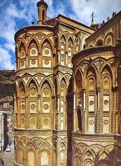 an old building with many windows and arches on the side of it's face