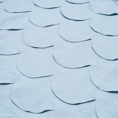 an image of blue fabric with wavy shapes