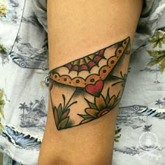 a woman's arm with a tattoo on it that has a triangle shaped object in the middle