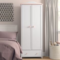 a bedroom with a white wardrobe and pink bedding