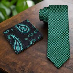 Elevate your ensemble with this sophisticated necktie featuring a timeless houndstooth pattern in shades of green and black. Crafted with meticulous attention to detail, this versatile accessory effortlessly combines classic style with modern elegance, making it a must-have addition to any wardrobe. Suggestions: Dress Shirt: Crisp White: Provides a clean and polished backdrop that allows the green and black hues of the tie to stand out, ensuring a timeless and refined look. Light Gray: Offers a Elegant Green Formal Neckwear, Elegant Green Tie With Pocket Square, Green Formal Tie With Pocket Square, Classic Green Neckwear For Business, Classic Green Suit And Tie Accessories For Semi-formal, Classic Green Suit And Tie Accessories For Semi-formal Occasions, Dapper Green Ties For Business, Elegant Green Tie For Work, Green Dapper Business Ties