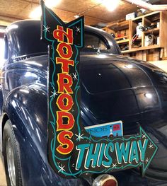 an old car with the word hot rod's this way on it is parked in a garage