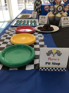 plates and cupcakes on a table at a race car themed birthday party,