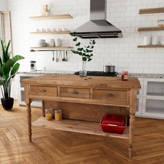 a kitchen with wooden flooring and white brick walls, an oven hood over the stove