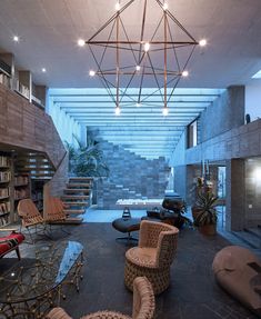 a living room filled with lots of furniture and bookshelves next to a fire place