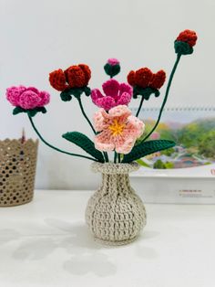 crocheted flowers in a vase on a table