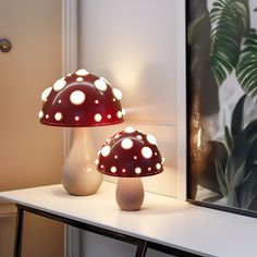 two mushroom lamps sitting on top of a white table