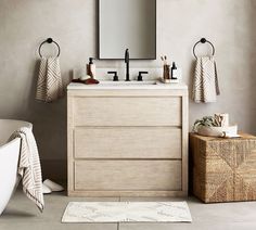 a bathroom with a sink, mirror and bathtub next to a rug on the floor