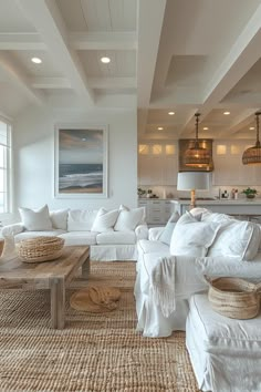 a living room filled with white furniture and lots of pillows on top of it's couches