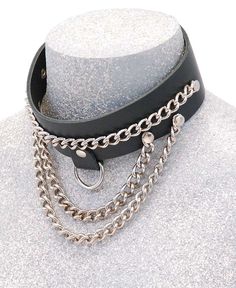 Chain choker necklace in heavy cowhide and chrome. This multi-chain leather choker with adjustable back snaps to fit most men and women. It is 1 3/8" wide cowhide leather choker fits a 14 1/2" to 15 1/2 " neck. This chain choker comes with two bottom swooping chain, a center nickel plated chain, and a center D-ring to attach other hardware if needed. Made with heavy 7-8 oz. cowhide leather. Made in USA. [1#] IMPORTANT SPECIFICATIONS: MADE IN USA: This item is American Made and hand crafted by our Jamin Leather's® talented sewing and manufacturing staff or company partner. No one makes quality leather accessories quite like Jamin Leather. LEATHER: Cowhide is a standard premium quality skin that is soft and supple to the touch. The grain is more even across all the panels of the product. The Punk Leather Jewelry For Festivals, Punk Leather Jewelry For Concerts, Edgy Leather Jewelry For Concerts, Edgy Leather Choker Jewelry, Edgy Leather Choker, Adjustable Edgy Leather Choker, Silver Leather Chain Jewelry, Leather Silver Jewelry For Concert, Adjustable Punk Style Chain Choker