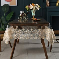 a table with a glass vase and flowers on it