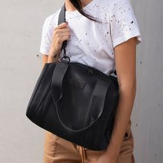 Our small Landon Carryall is the ultimate duffle bag for a full day ahead. Its petite size wont impede on a daily commute and when unsnapped at the sides, has enough space to hold a change of clothes for any post-work activity or to pick up a few things at the farmers market on weekends. The small Landon includes a stretch key leash and practical pockets for a tablet, charging cords and water bottle. A detachable cross-body strap provides more ways to carry it all with ease. We use 100% premium Dagne Dover, Small Travel Bag, Work Bags, Carry All Bag, Petite Size, Weekender Bag, Getting Things Done, The Block, Black Lives