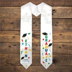 a white graduation stole with the words grad haun written on it and confetti