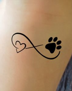 a woman with a tattoo on her stomach has a heart shaped paw and an arrow in the shape of a dog's paw