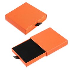 two orange boxes with black sides on a white background