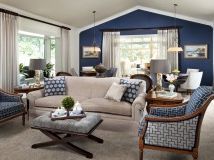 a living room filled with furniture and blue walls