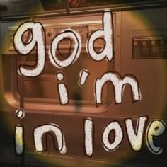 the words god i'm in love are painted on a subway car