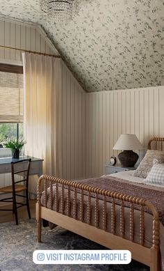 a bed room with a neatly made bed and a desk