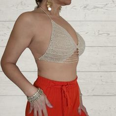 Introducing the Two-Way Crochet Cropped Top from Rita Rosa Brazilian Beachwear. Handcrafted with passion, this top embodies the elegance and versatility of sustainable fashion. Available in earthy beige and vibrant red, it flatters your shape and accentuates your style. Each piece is meticulously handmade, ensuring uniqueness. It features eco-friendly materials, padded cups for comfort and support, a fashionable halter neckline, and delicate lace straps. The innovative two-way design allows vers Fitted Beige Crochet Top For Party, Fitted Triangle Beige Crop Top, Beige Fitted Triangle Top, Fitted Beige Triangle Crop Top, Beige V-neck Crop Top For The Beach, Chic Fitted Crochet Top For Festival, Fitted Beige Crop Top For Vacation, Beige Triangle Crochet Top For Summer, Beige Open Knit Crop Top For Summer