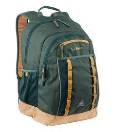 a green backpack with gold trims on the bottom