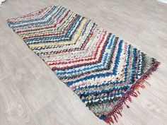 a multicolored area rug on the floor