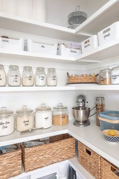 an organized pantry with jars and baskets