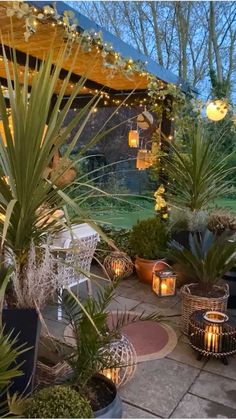 an outdoor patio with potted plants and candles