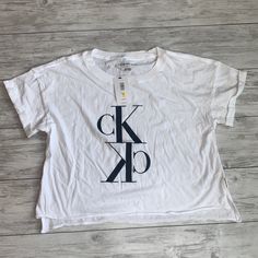 Calvin Klein Jeans Tshirt White Crop Size Medium New New With Tags Nwt Tie Dye Crewneck Sweatshirts, Jeans Tshirt, Calvin Klein Hoodie, Things I Need To Buy, White Halter Top, Calvin Klein Shorts, Calvin Klein Jeans Women, Long Sleeve Floral Top, White Button Down Shirt