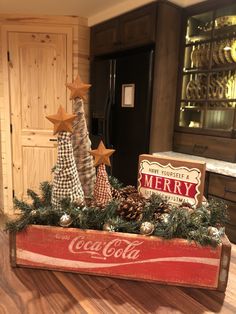 a coca - cola crate filled with christmas decorations