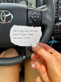 a woman holding a piece of paper with the words don't say god has been silent if your bible